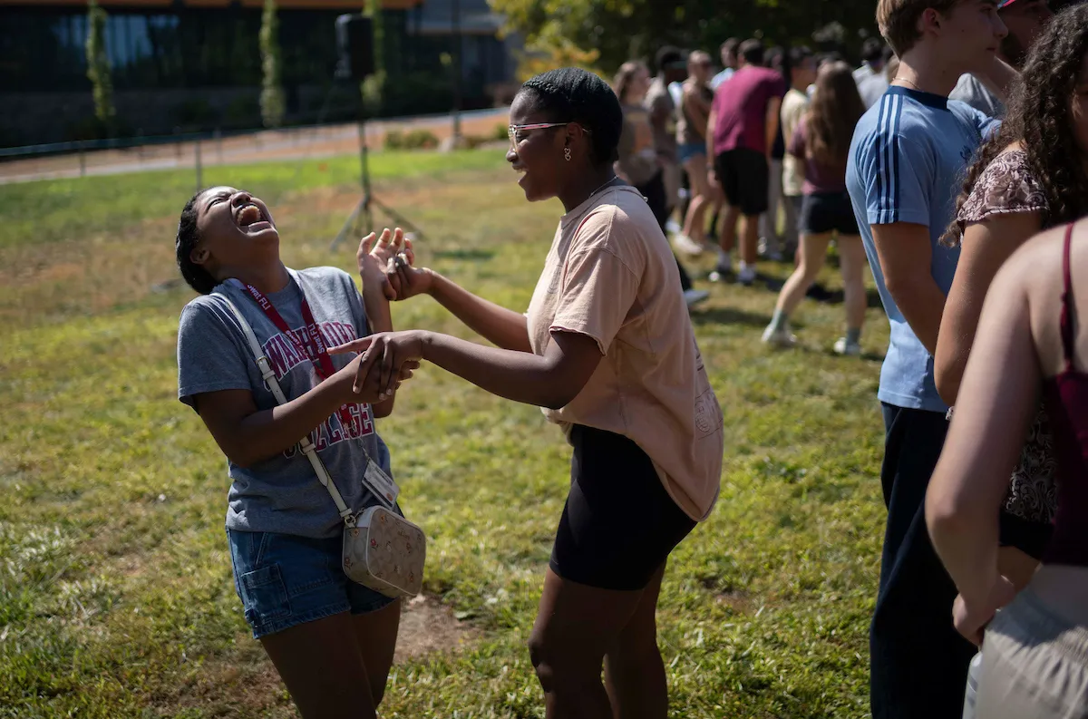 Students laugh and hug during orientation events