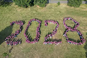 Class of 2028 members form giant "2028" on lawn