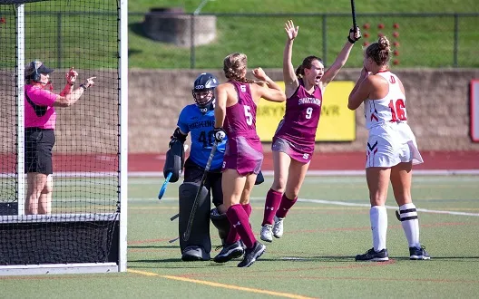 Field hockey player celebrates goal
