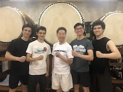 group in front of drums