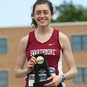 Katie Jo McMenamin holds trophy and stands at podium