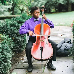 Student plays cello outdoors