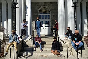 Students sitting outdoors on steps of Parrish Hall