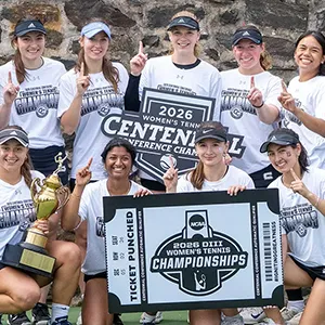 Women's tennis team celebrates with trophy